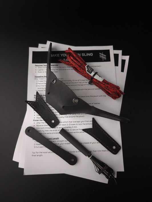 A leather pouch and matching leather loops laid out on top of printed instruction sheets, with a red-and-black braided cord and needle and thread kit placed beside them on a black background.